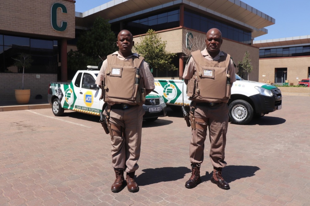 Fidelity ADT armed response officers beside marked response vehicles