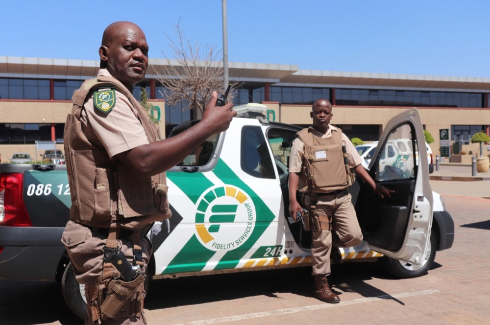 Fidelity ADT officers responding beside a branded response vehicle